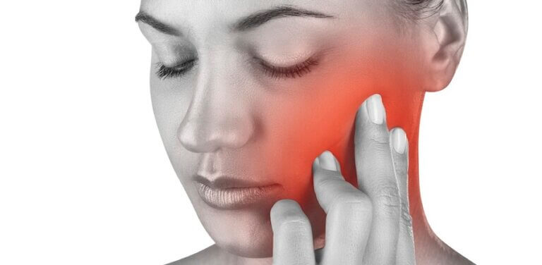 Woman experiencing jaw pain