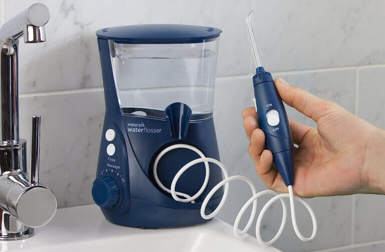 Waterpik water flosser on bathroom counter